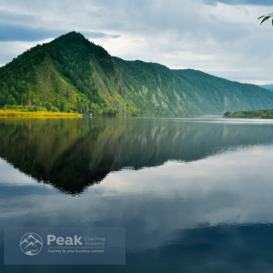 Peak Coaching Academy Logo - image of a lake and mountain.