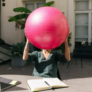 Office Worker holding a Yoga Ball